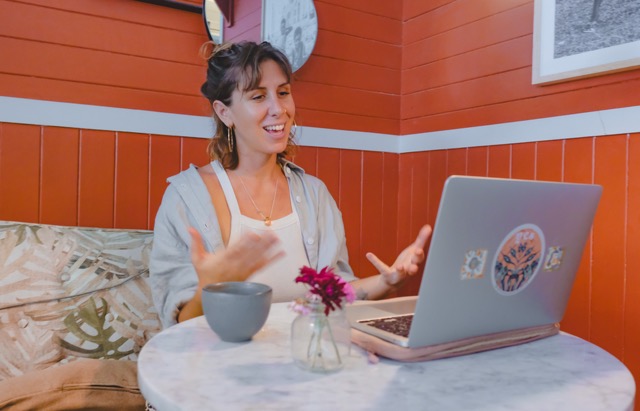 Bénédicte Donet during a video consultation, smiling in front of her computer